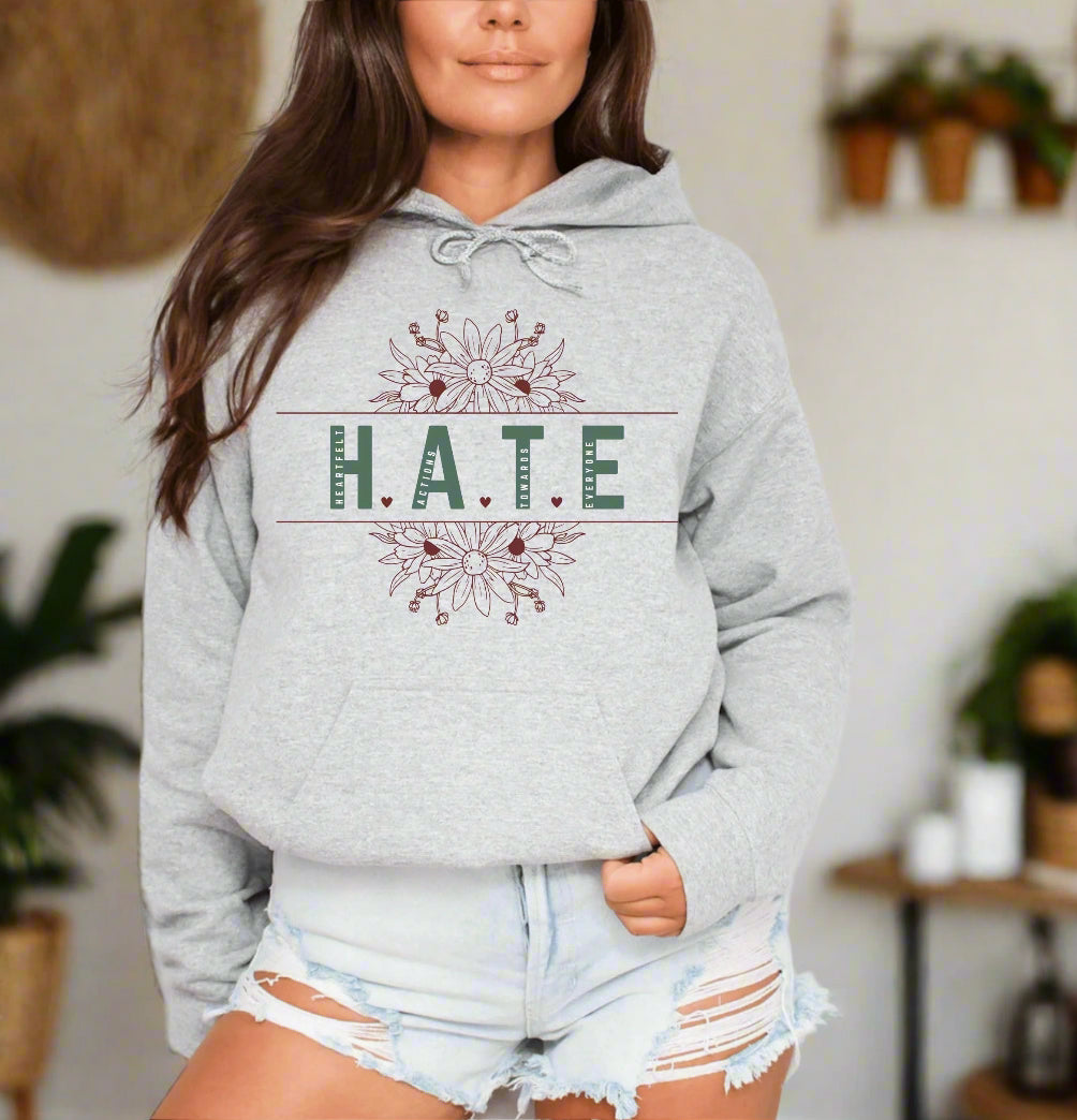 a woman wearing a grey hoodie that says hate