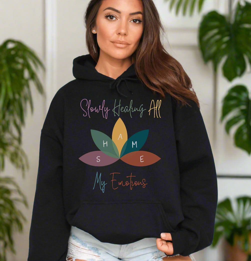 a woman wearing a black hoodie with a flower on it