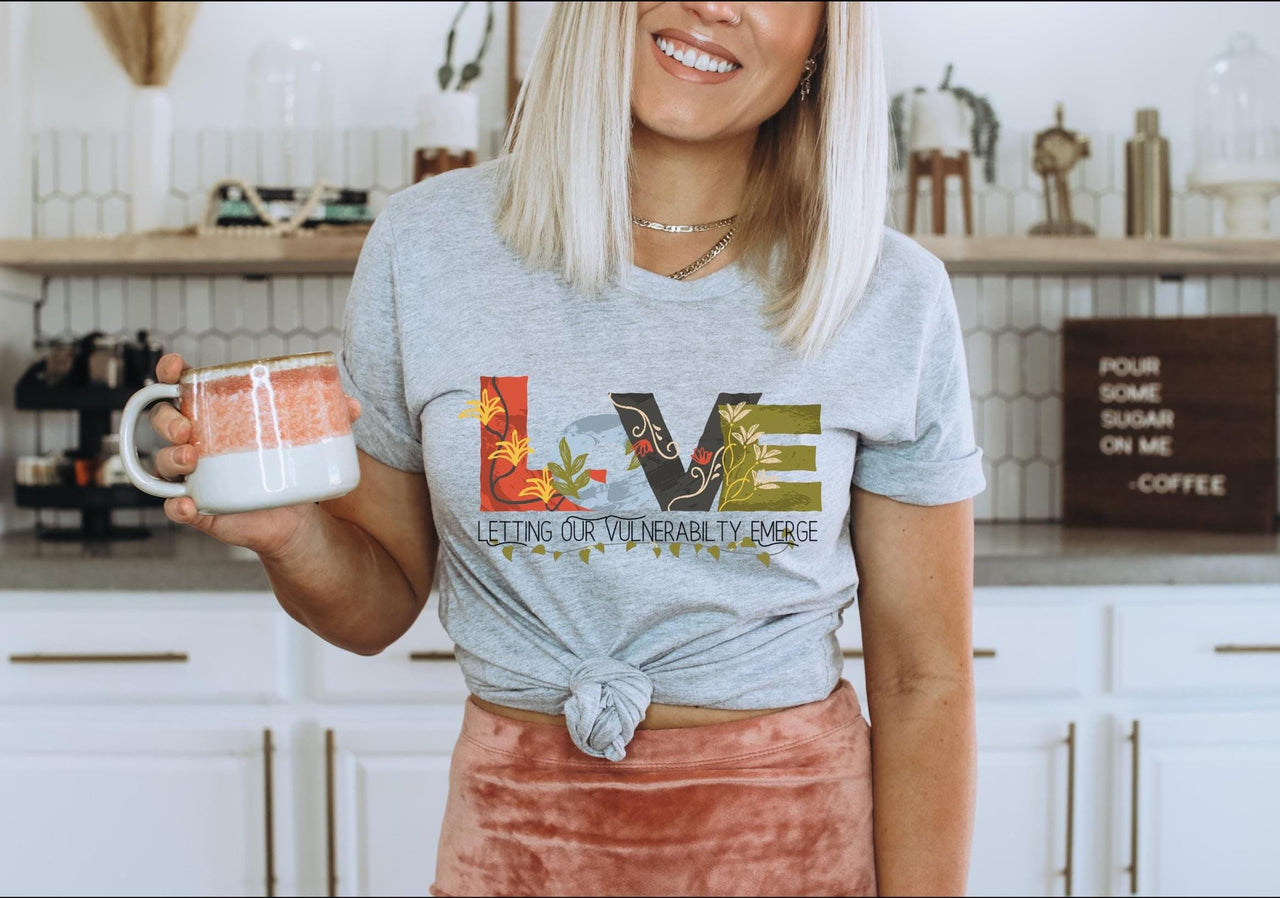 a woman holding a mug in a kitchen