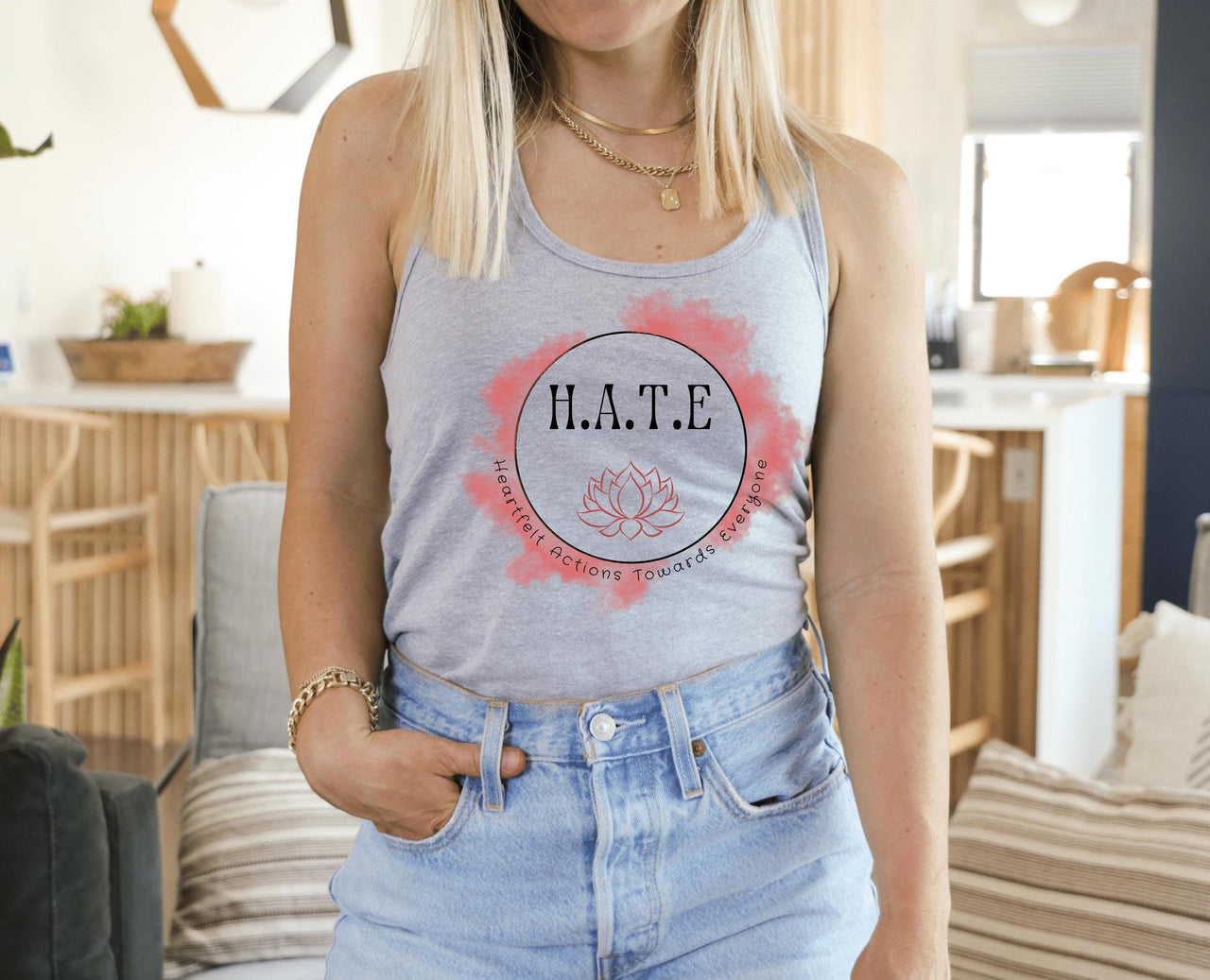 a woman standing in a living room wearing a tank top