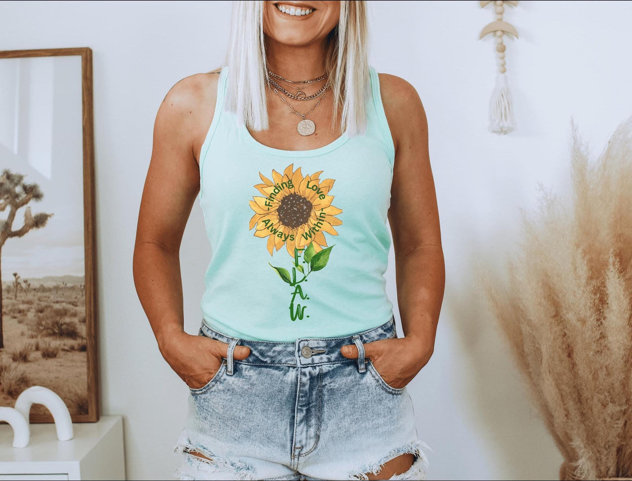 a woman wearing a tank top with a sunflower on it