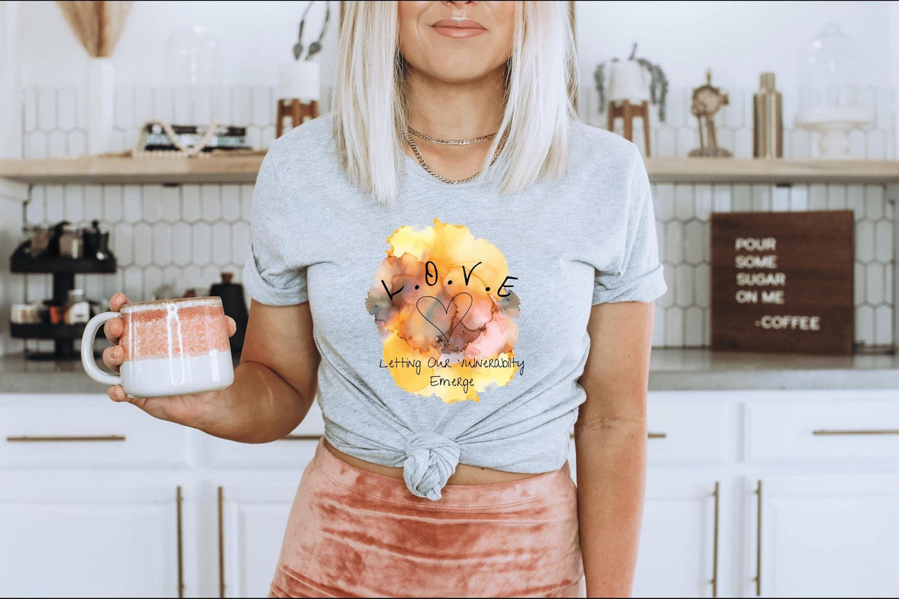 a woman holding a cup of coffee in a kitchen