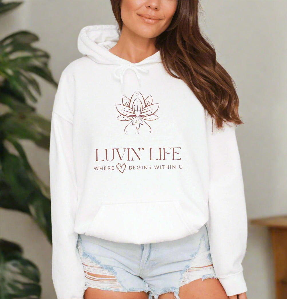 a woman wearing a white hoodie with the luvin'life logo on it