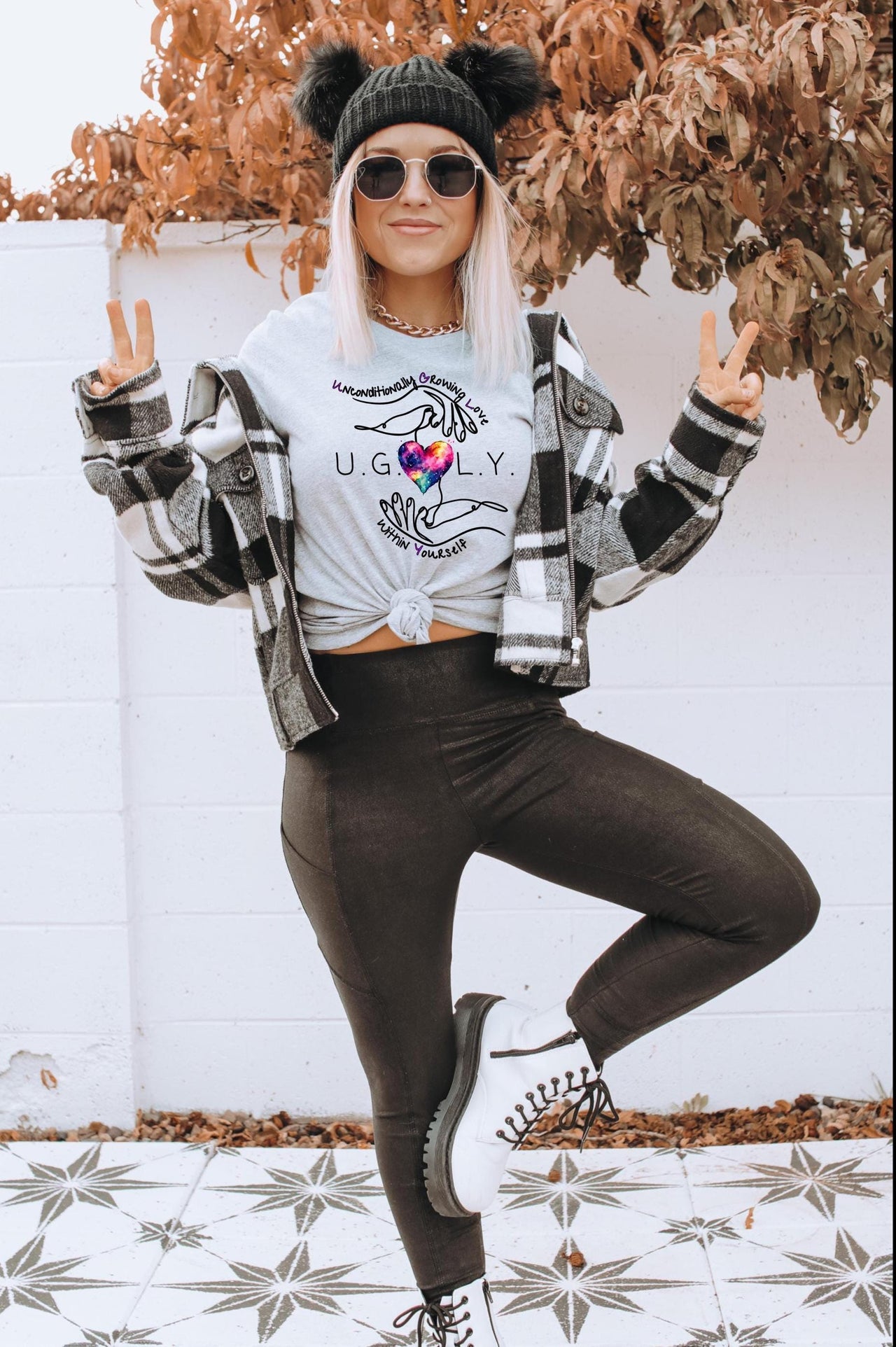 a woman in a white shirt and black leggings