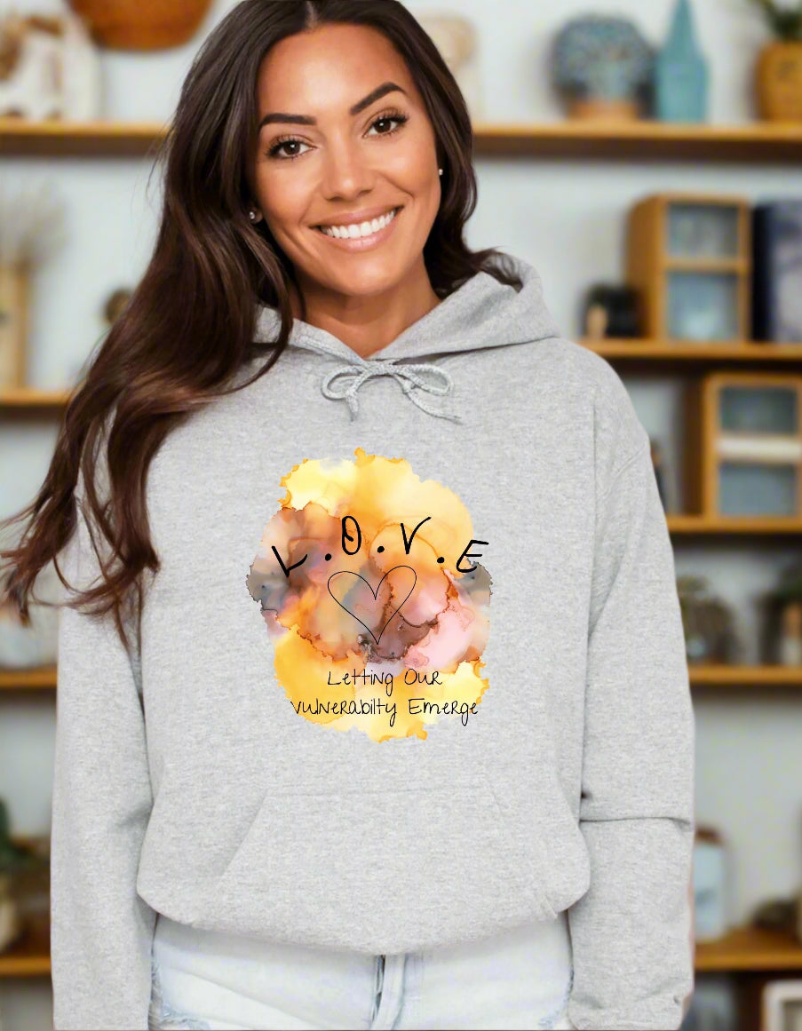 a woman wearing a grey hoodie with a picture of two elephants on it