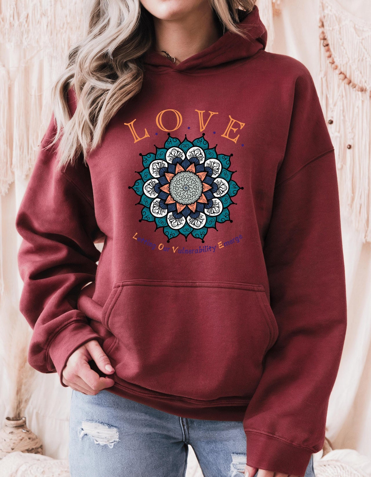 a woman wearing a red hoodie with the words love on it