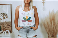 Thumbnail for a woman standing in front of a wall wearing a white tank top