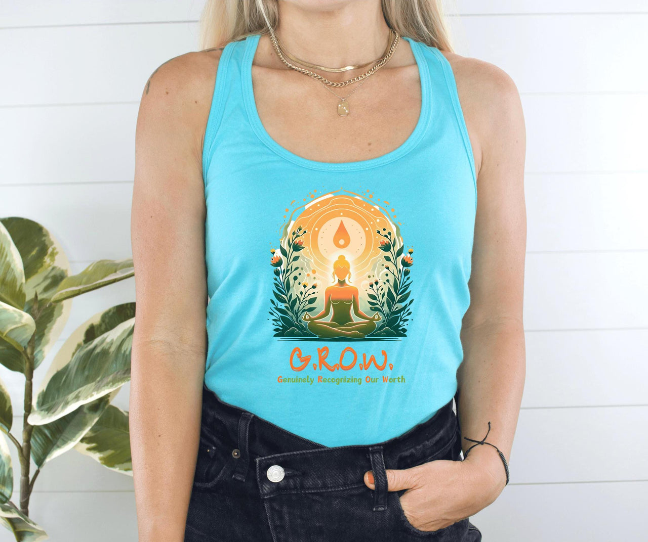 a woman wearing a blue tank top with a tree on it