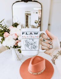 Thumbnail for a woman holding a coffee mug with a drawing on it