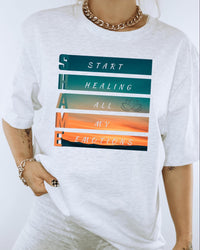 Thumbnail for a woman wearing a white t - shirt that says start healing all my emotions